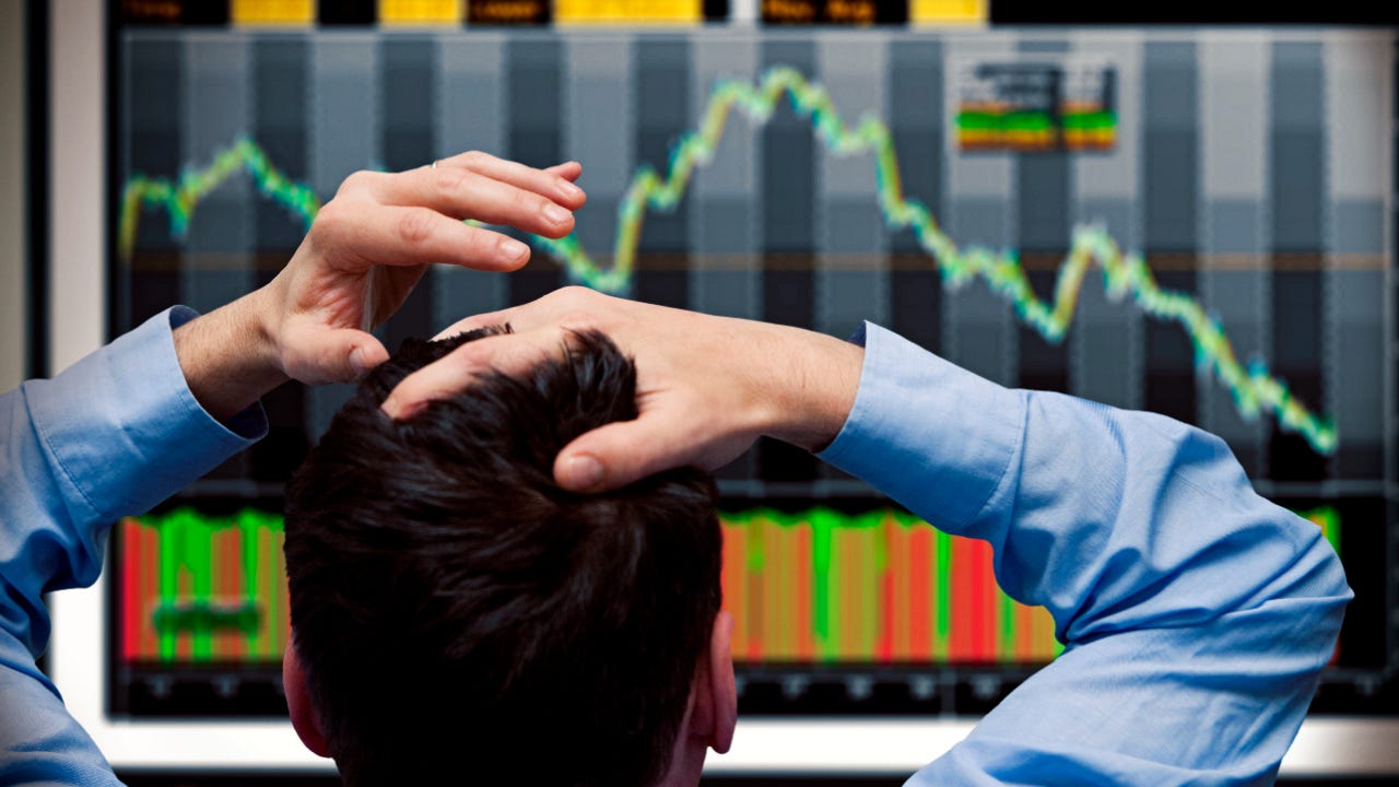 Trader looks at plummeting stock chart