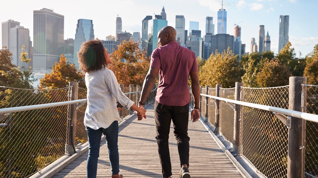 couple holding hands while visiting New York City