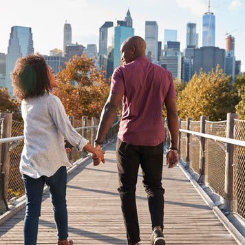 couple holding hands while visiting New York City