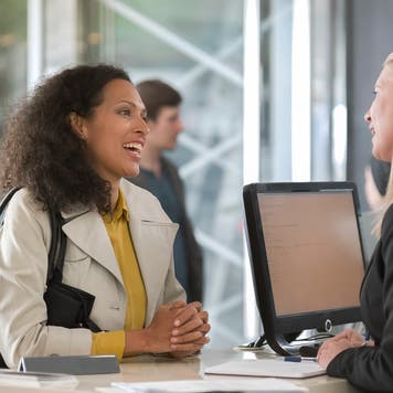 Women talks to employee at a bank counter
