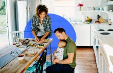 couple with a young baby in home kitchen
