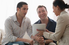 Gay couple talking to a real estate agent