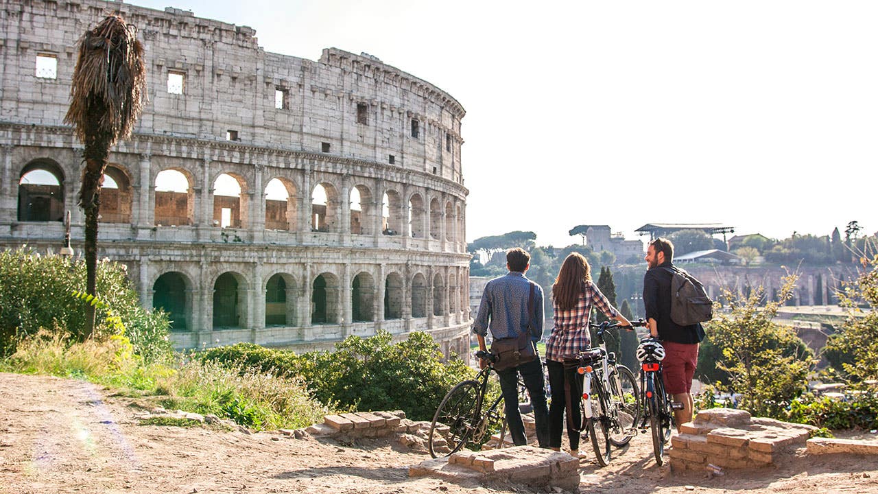 friends bicycling in rome