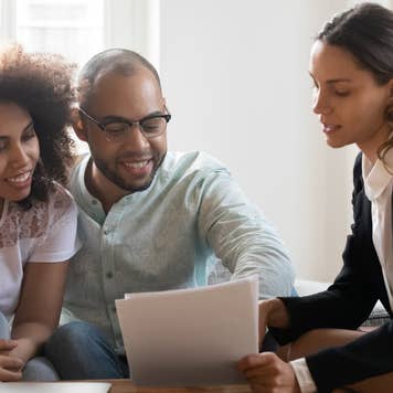 Couple discussing contract terms during meeting with realtor