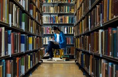 Student studies in a college library