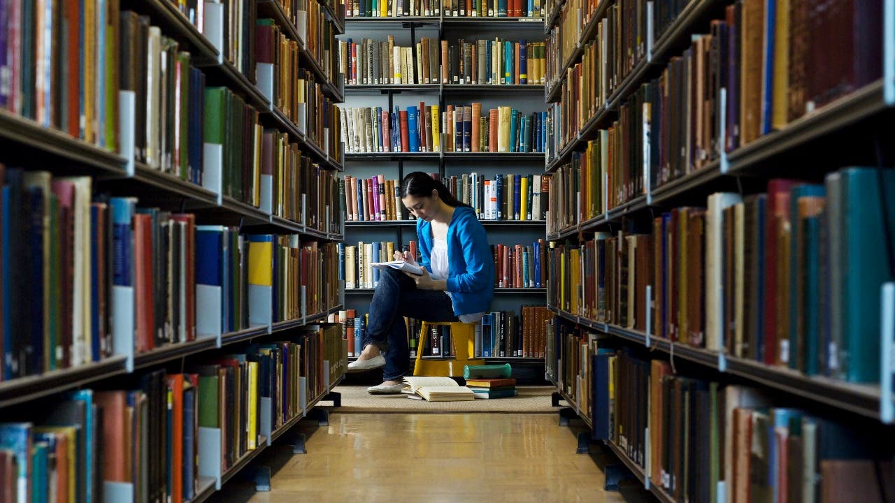 Student studies in a college library