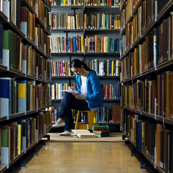 Student studies in a college library