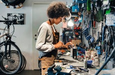 female mechanic working in bicycle shop