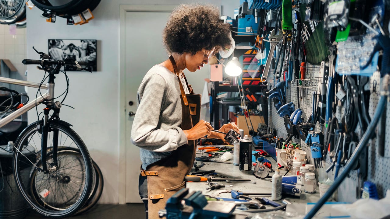 female mechanic working in bicycle shop