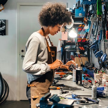 female mechanic working in bicycle shop