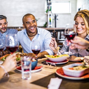 group of people eating a meal together at a restaurant