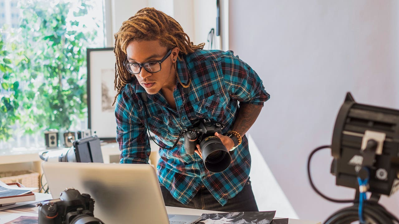 photographer checking his laptop in his studio