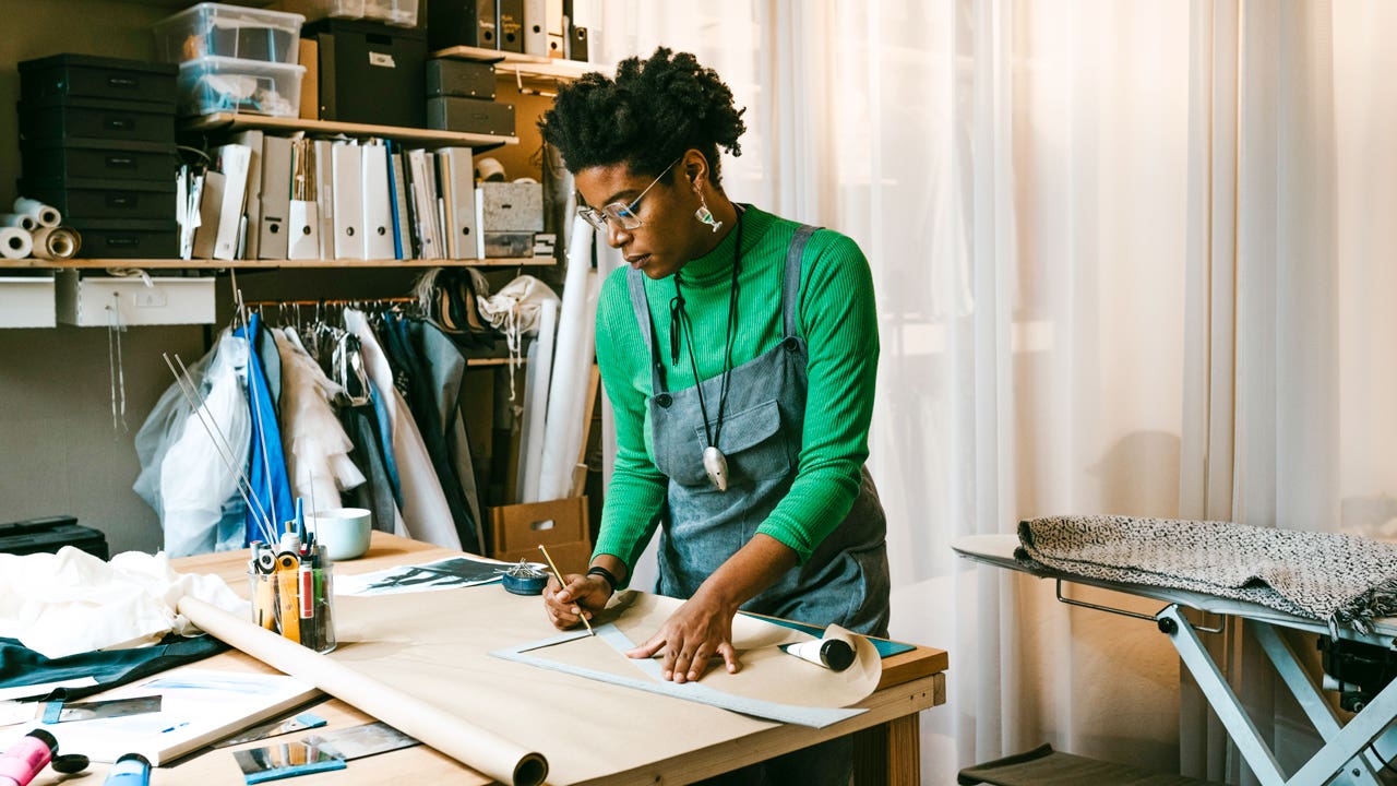 woman working on craft project at a table in her living room