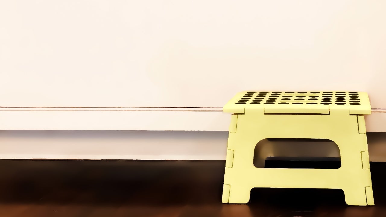 A child's step stool in front of a cabinet