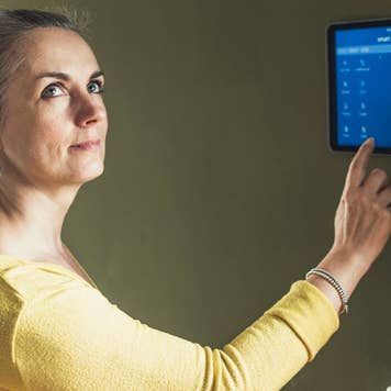 Woman adjusting the lights in her home