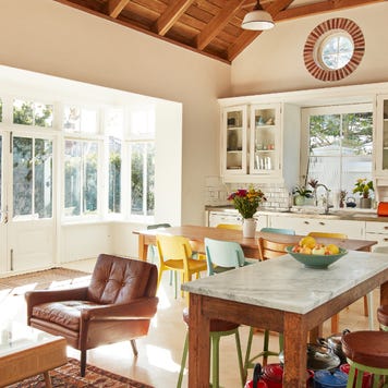 An open floor plan great room with living, dining and kitchen areas in the frame