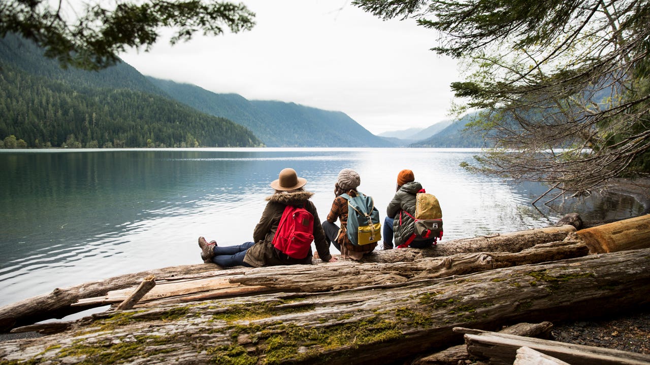 group of friends on a hike by a lake