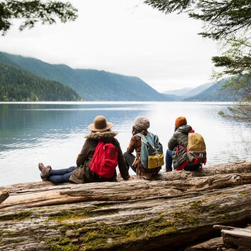 group of friends on a hike by a lake