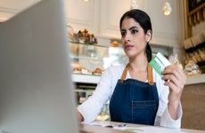 bakery owner making an online purchase with her credit card