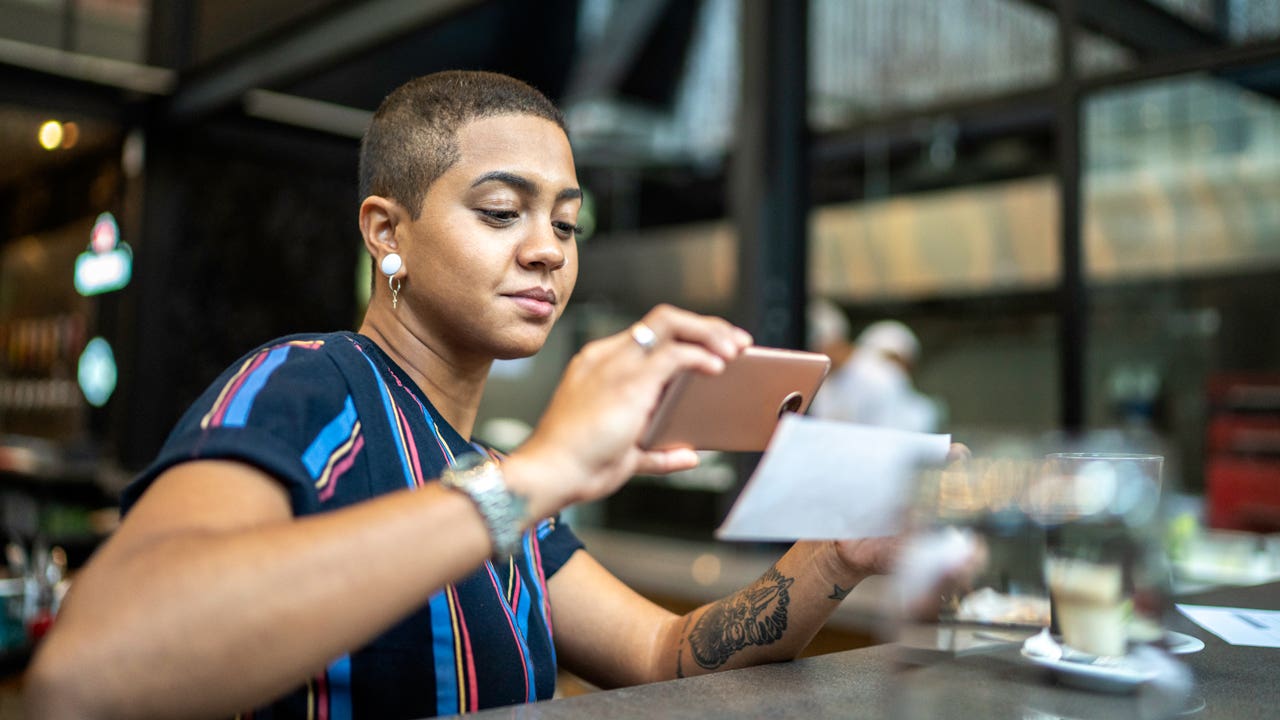 woman depositing a check on her phone