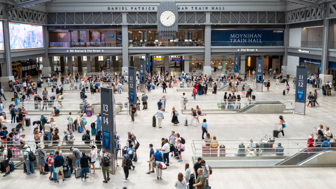 Travelers move through the Moynihan Train Hall in Manhattan