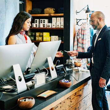man paying with a credit card in a clothing store