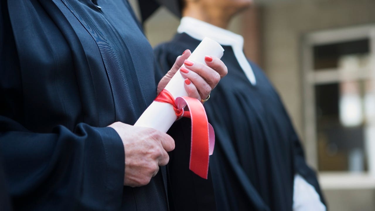 Close-up of hands with a diploma