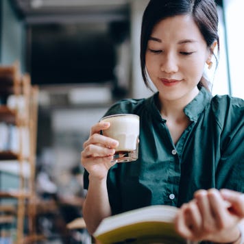 Woman reads a book in a cafe