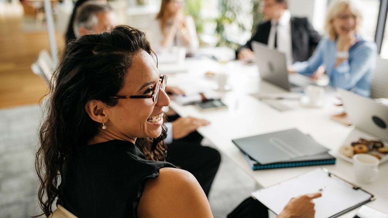 Candid close-up of Hispanic businesswoman in office meeting