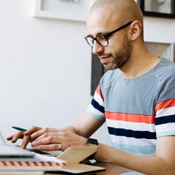 man working on his laptop computer