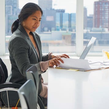 businesswoman who uses a wheelchair working in an office