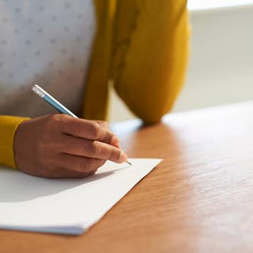 Taking notes with pencil and paper