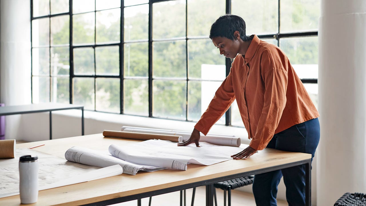 architect working at a table in her office