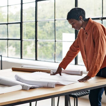 architect working at a table in her office