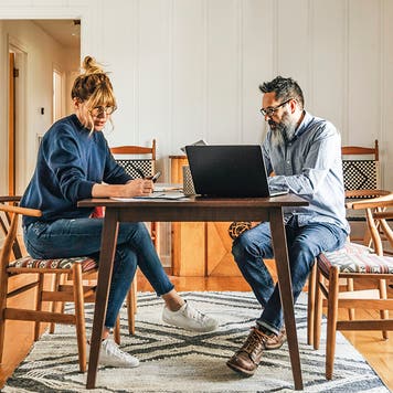 Side view of couple paying bills