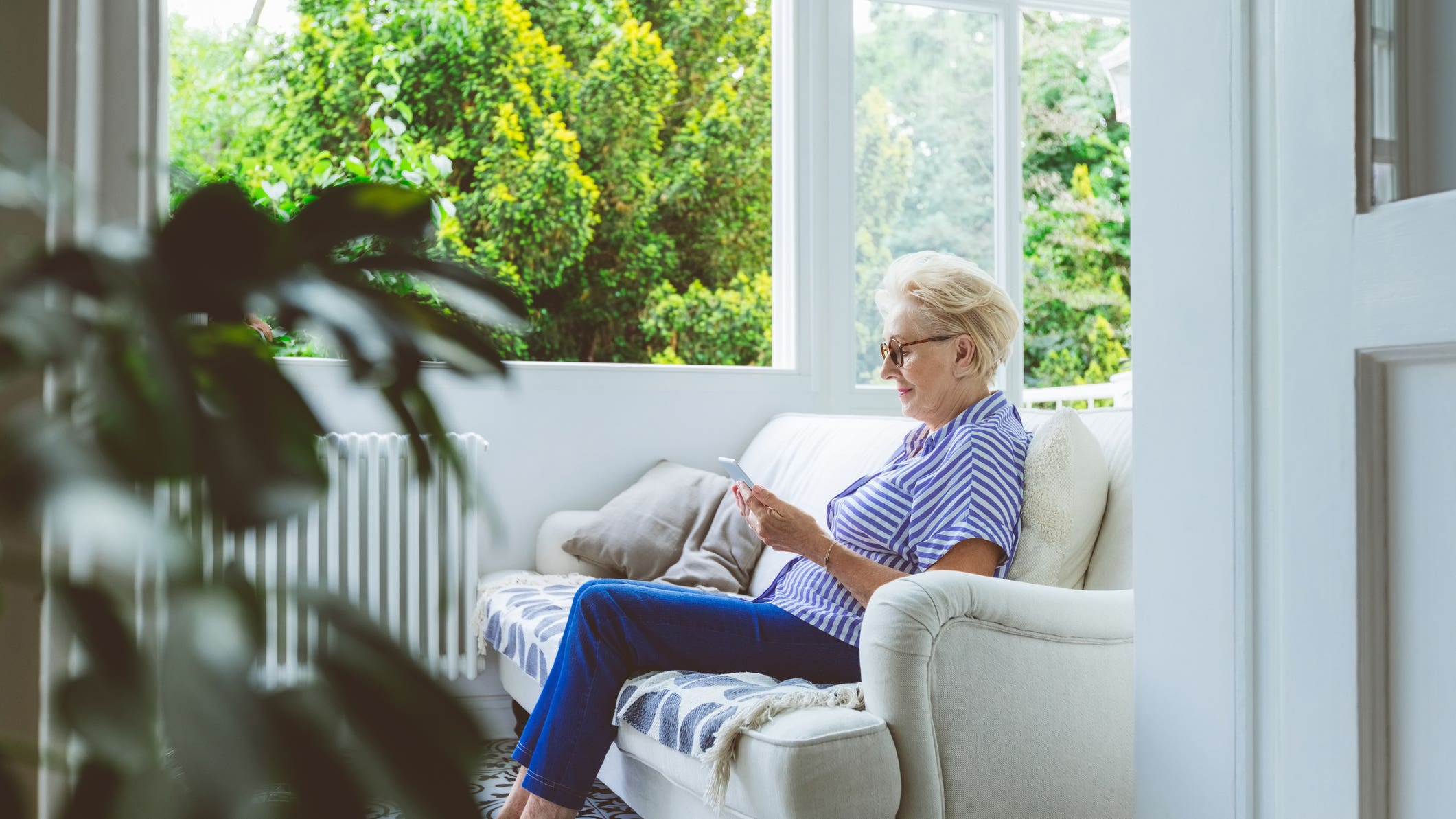 Senior woman using tablet PC at home