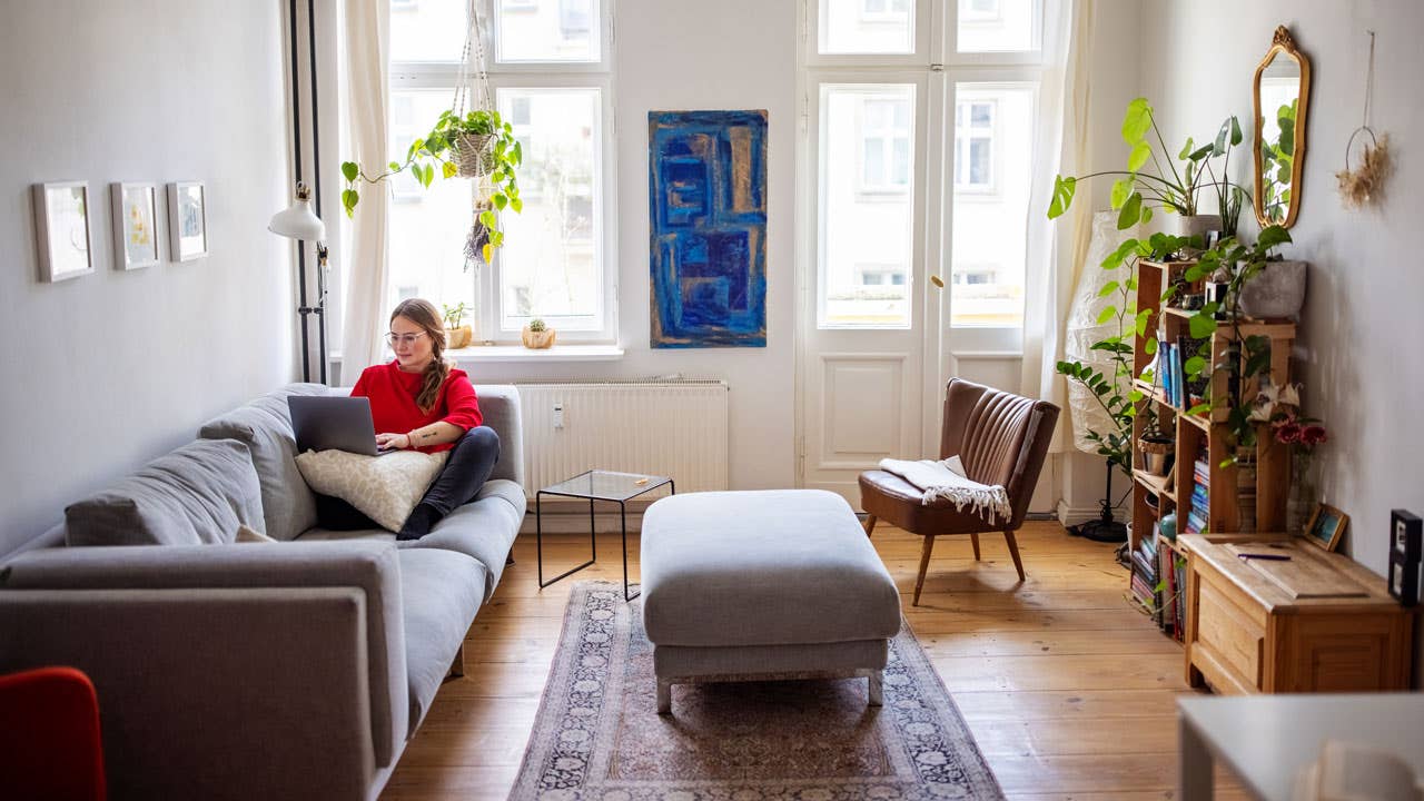 young woman sitting on the couch in her apartment