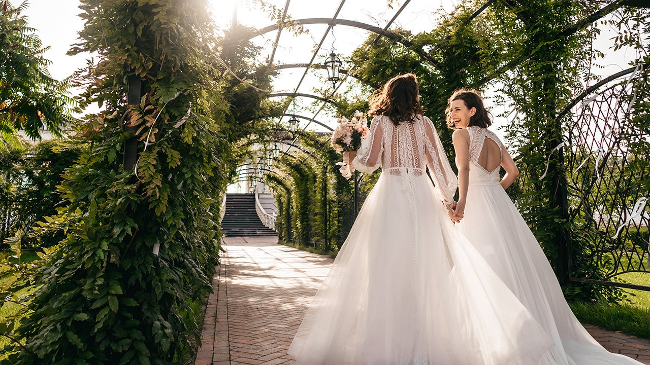 two happy brides walking outside during wedding