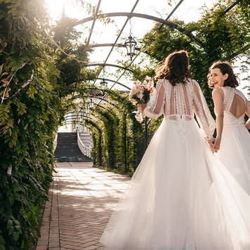two happy brides walking outside during wedding