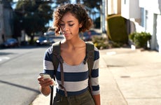 woman walking and looking at a phone