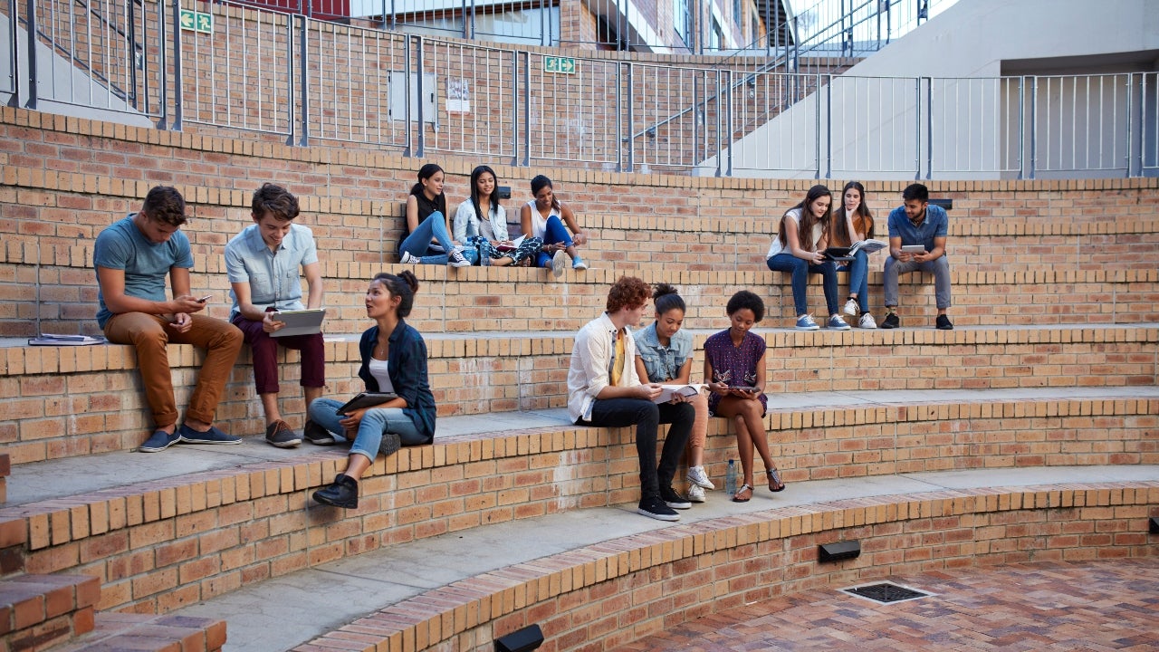 Group of college students sits on campus