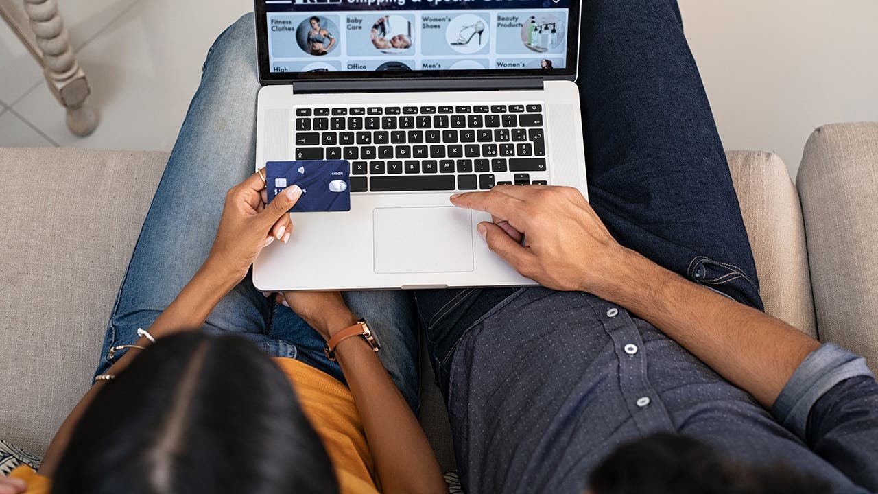 couple shopping online with a credit card