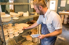 pottery studio owner taking inventory