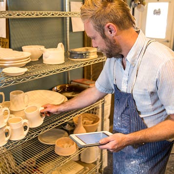 pottery studio owner taking inventory