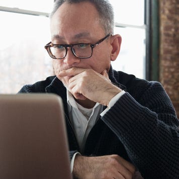 Man using laptop, with stern face