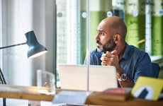 man in an office looking out the window