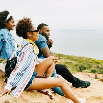 group of friends enjoying the view in a park overlooking the water