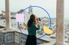 design element including a women taking a photo from a balcony