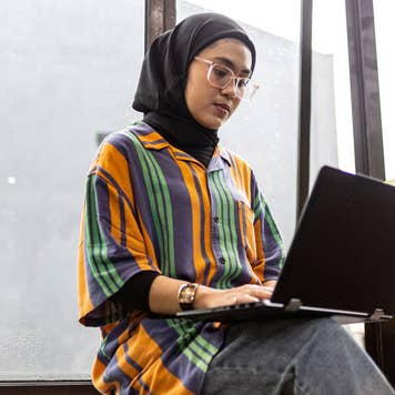 young woman working on her laptop