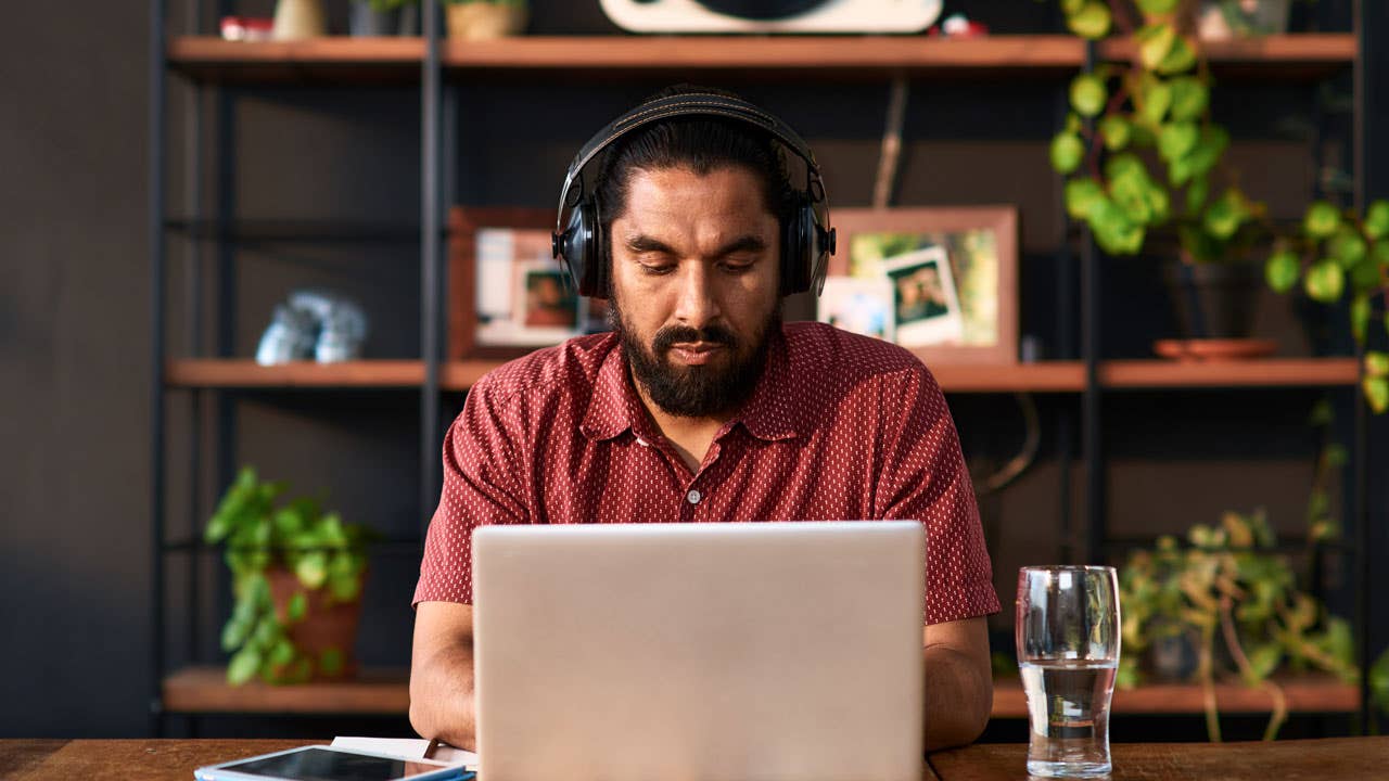 man with headphones working on his computer